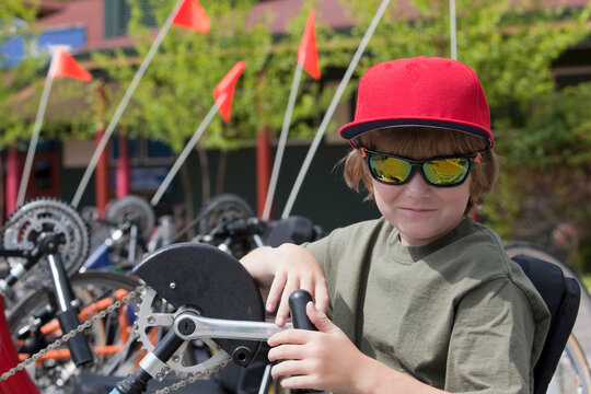 Boy with degenerative disease participating in handcycle race - Powered by Adobe