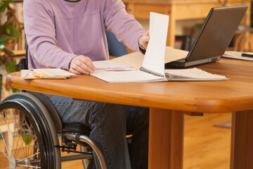 Businesswoman with multiple sclerosis doing paperwork at home
