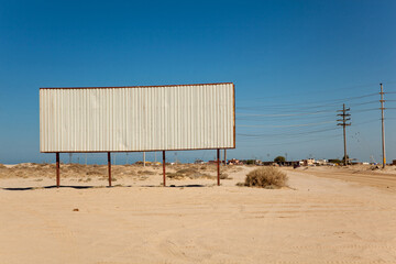 Blank billboard in the middle of desert landscape