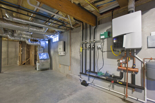 Heating and A/C system, photovoltaic inverter, and tankless hot water system in the basement of a Green Technology Home