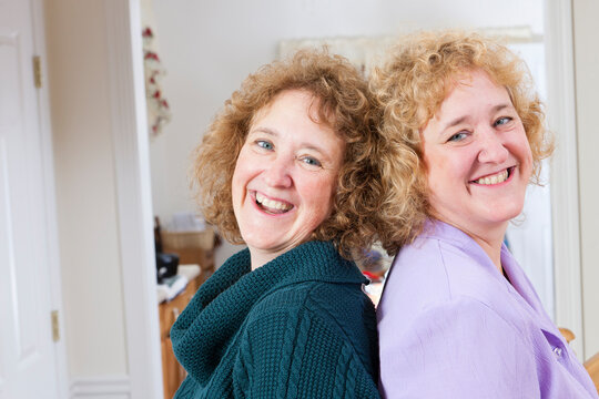 Portrait of twin sisters smiling