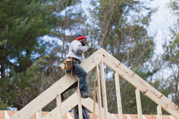 Carpenter working on a roof peak