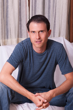 Portrait of a man sitting on a couch