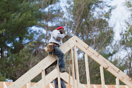 Carpenter working on a roof peak