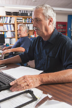 Two engineers on computers starting up the water treatment plant in program for supervisory control and data acquisition