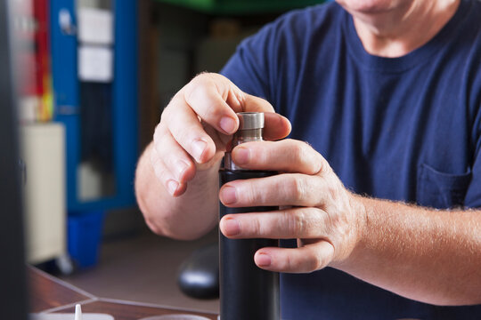 Engineer rebuilding an O2 electrochemical sensor probe in a laboratory