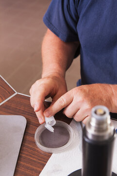Engineer adding polishing powder to polishing pad with O2 electrochemical sensor in laboratory