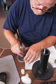 Engineer polishing O2 electrochemical sensor probe in laboratory