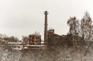 Old abandoned industrial factory building. Ruined historic building. Chimney pipe