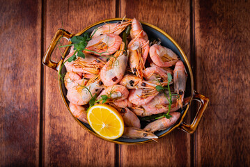 boiled shrimp with lemon on a wooden background
