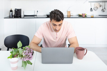 Young businessman working on laptop at home. Distant work concept	
