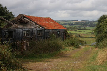 Fototapeta na wymiar Shed with red corrugated roof - Mount Eagle - County Kerry - Ireland