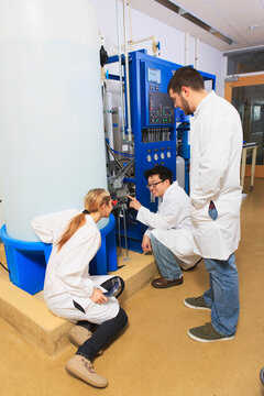 Engineering students discussing equipment in water ultra purification system room in a laboratory