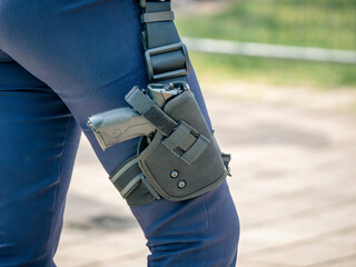 The gun or pistol of a romanian police officer in holster. Close up.