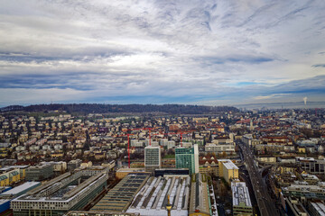 Obraz premium Aerial view of City of Zürich seen from industrial district with Waidberg and Käferberg in the background on a cloudy winter day. Photo taken December 20th, 2022, Zurich, Switzerland.