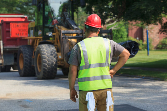 Construction worker watching front end loader