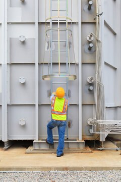 Engineer at sound suppression stage of gas turbine which drives generators in power plant