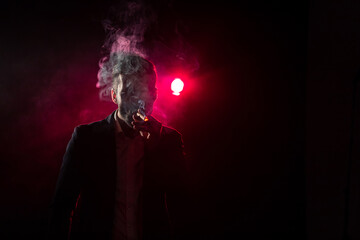 Photo of smoking man on pink background.