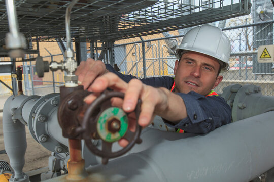 Industrial engineer checking valve closure at a power plant
