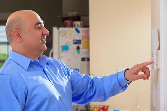 Man setting home security system