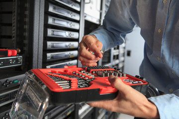 Network engineer in data center selecting hand tool bit