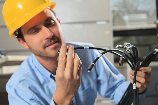 Network engineer examining cable termination connector