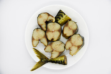 Cold smoked fish on a white plate. Delicious herring. Smoked herring.