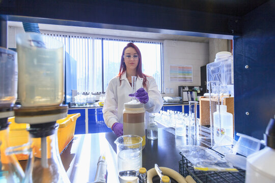 Lab chemist preparing graduated cylinder for standard solution