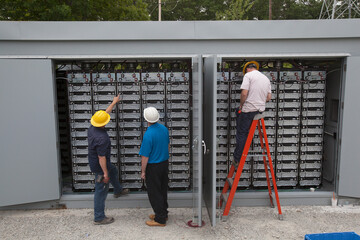 Tradesmen working on electrical components outside