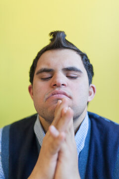 Middle Eastern man with Down Syndrome thinking