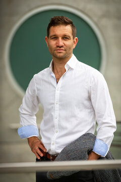 Businessman standing and looking at the camera in a casual pose; Vancouver, British Columbia, Canada