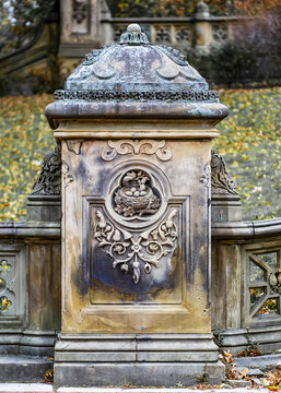 Decorative stone post with floral and nature elements embellishing the front, autumn in Central Park, Manhattan; New York City, New York, United States of America