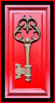 Painted door in bright red with a large decorative skeleton key; Edmonds, Washington, United States of America