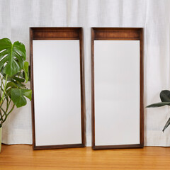 Two Mid-century modern frame mirrors. Minimalist, vintage walnut bedroom furniture. On display with...