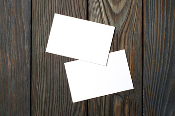 Two blank cards (business cards, tickets, flyers, invitations, coupons, banknotes, etc.) on dark...