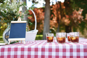 Summer background with tintos de verano on a checkered tablecloth in a typically Spanish open-air cocktail