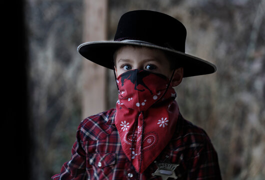 Boy poses in his cowboy outfit; Prineville, Oregon, United States of America