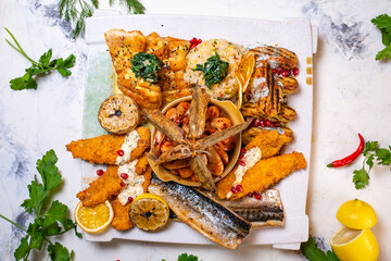 top view of shrimp and fish in assortment on a festive white plate