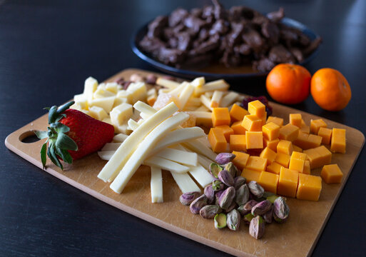 Variety of healthy foods ready to serve on a wooden board and plate; Studio