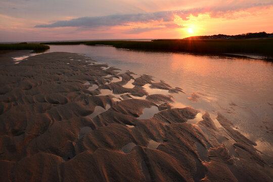 Sunrise over Payne's Creek estuary and tidal flats in Brewster, Cape Cod.; Brewster, Massachusetts, USA.