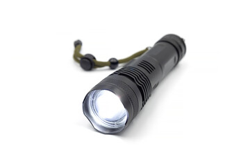 Glowing Black metallic Led Flashlight isolated on white background. Core Torch Zoom