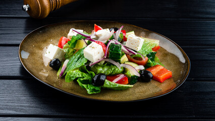 classic greek salad of organic vegetables with tomatoes, cucumber, red onion, olives and feta cheese