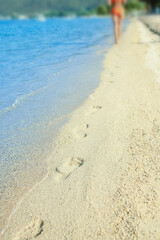 A Feet and footprints by the seashore in nature travel vacation background