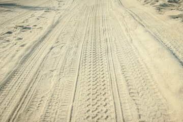 A Traces of a car in the sand near the sea in nature background