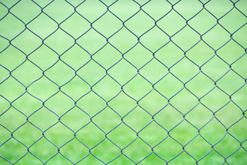 Fototapeta premium Wire fence with green background