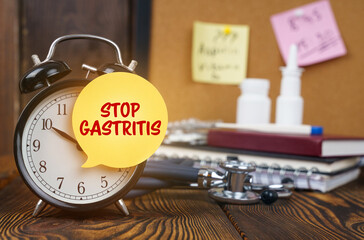 On the alarm clock a sticker with the inscription - STOP GASTRITIS