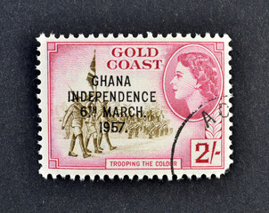 cancelled postage stamp printed by Ghana, that shows Gold Coast Regiment Trooping the Colour - overprinted, circa 1957.