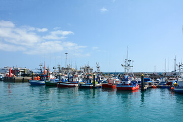 Fototapeta na wymiar Colorful fishing boats in Los Cristianos Harbour, Tenerife, Spain
