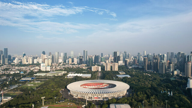 Aerial top down view of the Beautiful scenery of Senayan Stadium. with Jakarta cityscape background. Jakarta, Indonesia, December 21, 2022