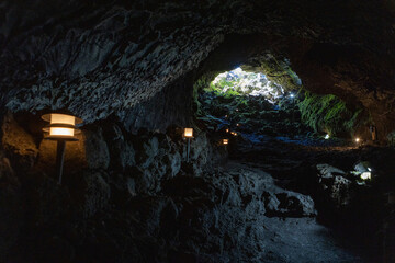 Eploring a volcanic cave in the Volcanic Caves Park at the foot of Villarrica volcano in Pucon,...